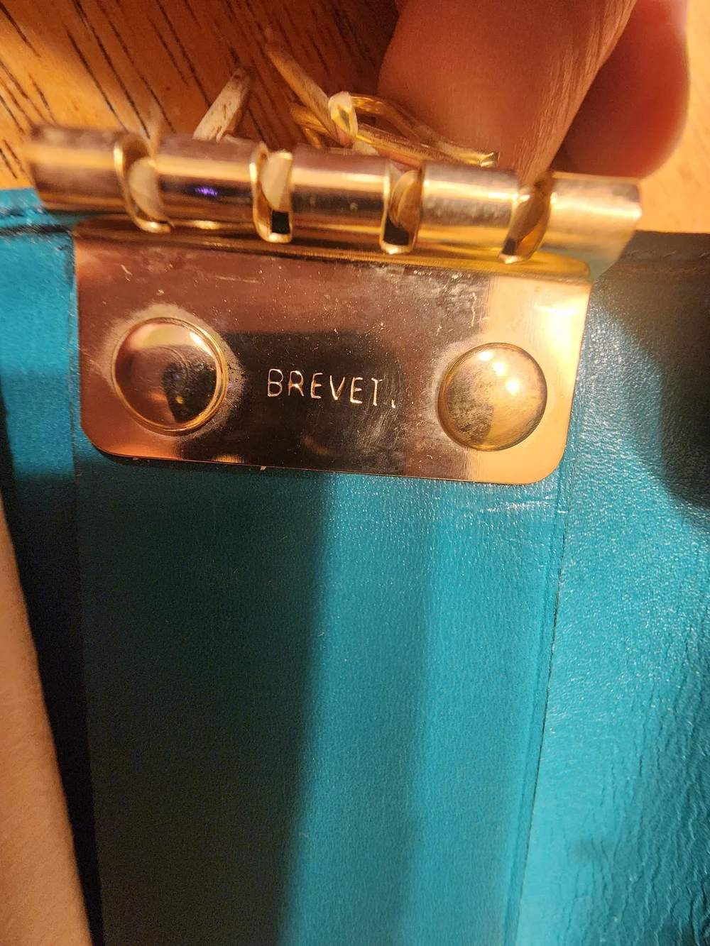 vintage Gucci teal leather key case featuring a distinctive cabochon stone
